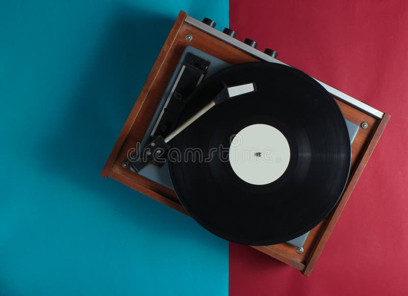 Retro vinyl record player on red-blue background. Top view. Retro vinyl record player on red-blue background. Top view